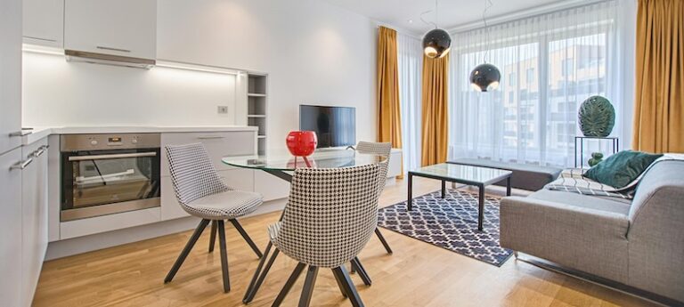 A contemporary apartment featuring an open kitchen and living room, showcasing modern design and spacious layout.